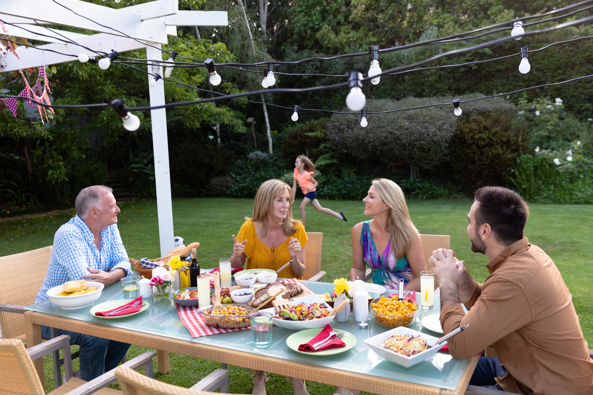 family at home in their garden - Rattan dining set