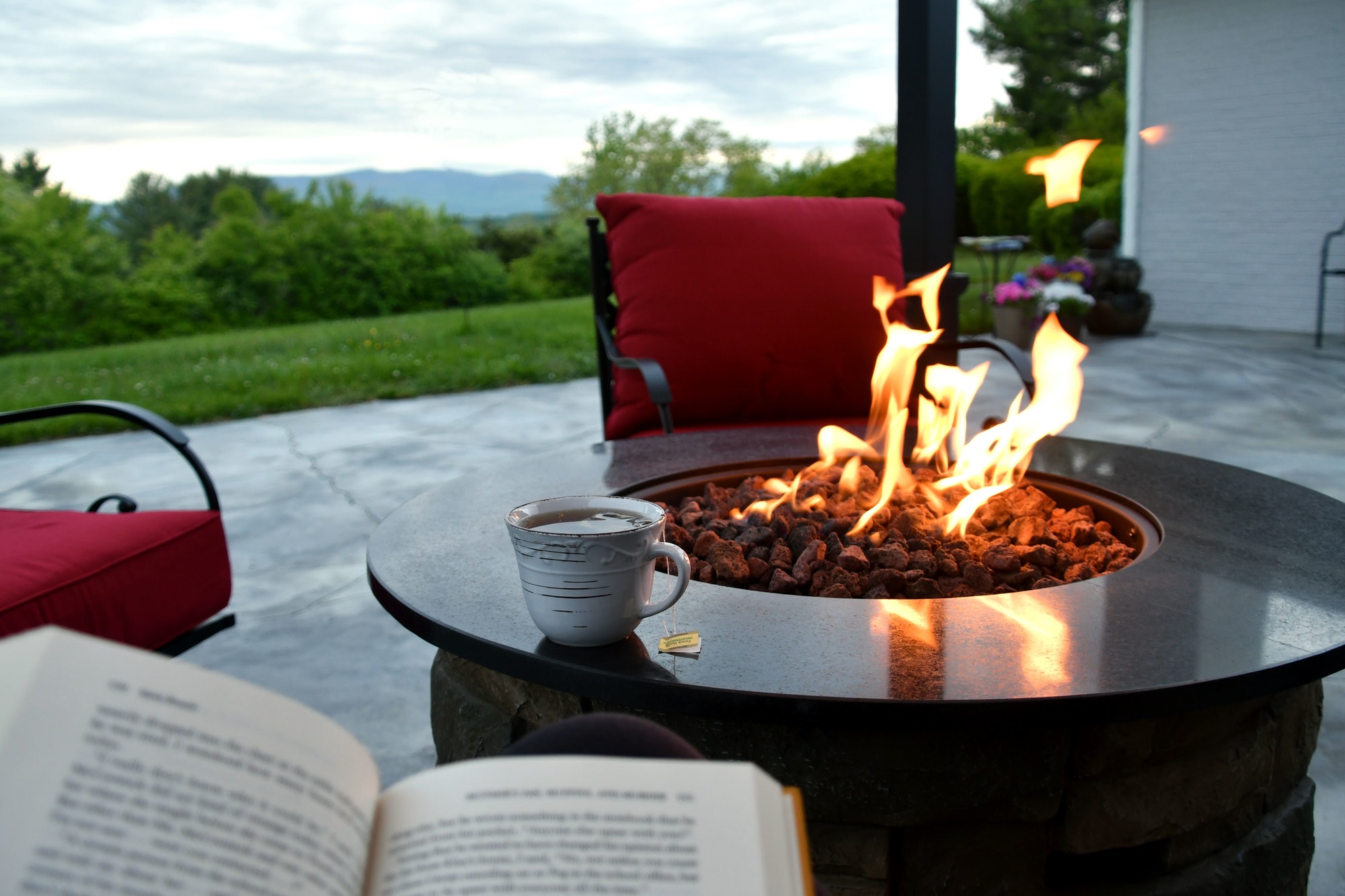 Enjoying a cup of tea, a good book and the view while relaxing by the gas fire pit on the patio